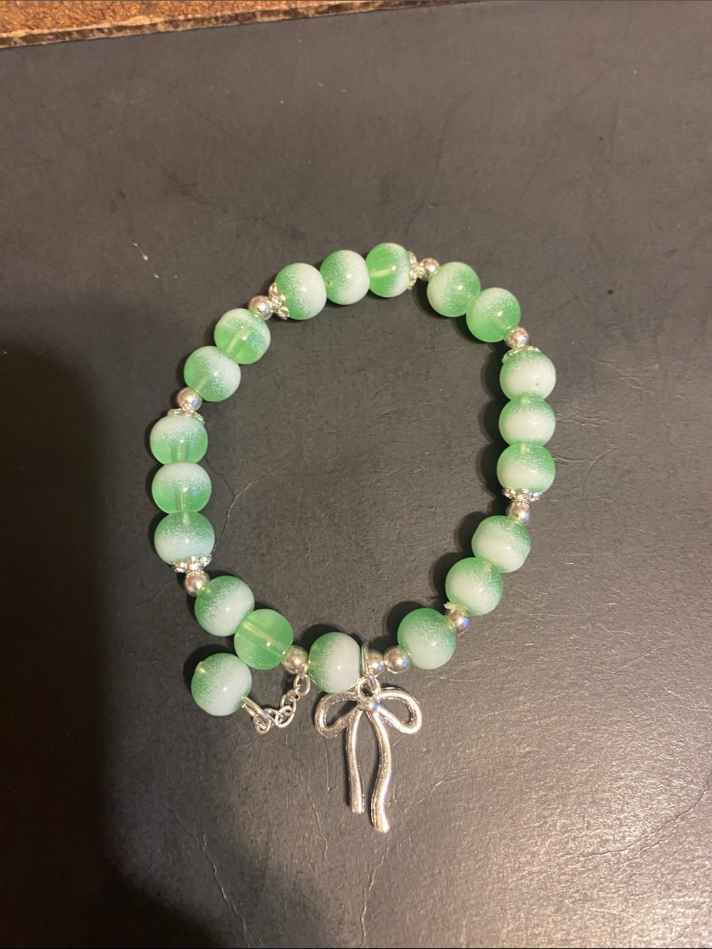 Green Beaded Bracelet with Silver Bow Charm